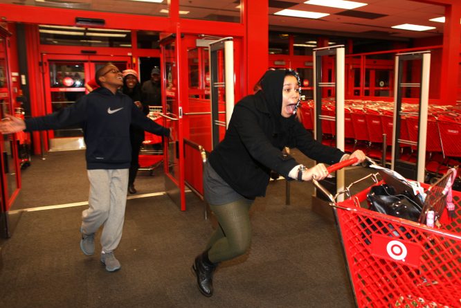 In this Thursday evening, Nov. 22, 2012 photo, Bianca Ward, 20, screams as she enters a Target store in Chesapeake, Va. Hundreds of people lined up early for the Thanksgiving Day sale. Ward had waited in line since the afternoon. (AP Photo/The Virginian-Pilot, Ross Taylor) MAGS OUT